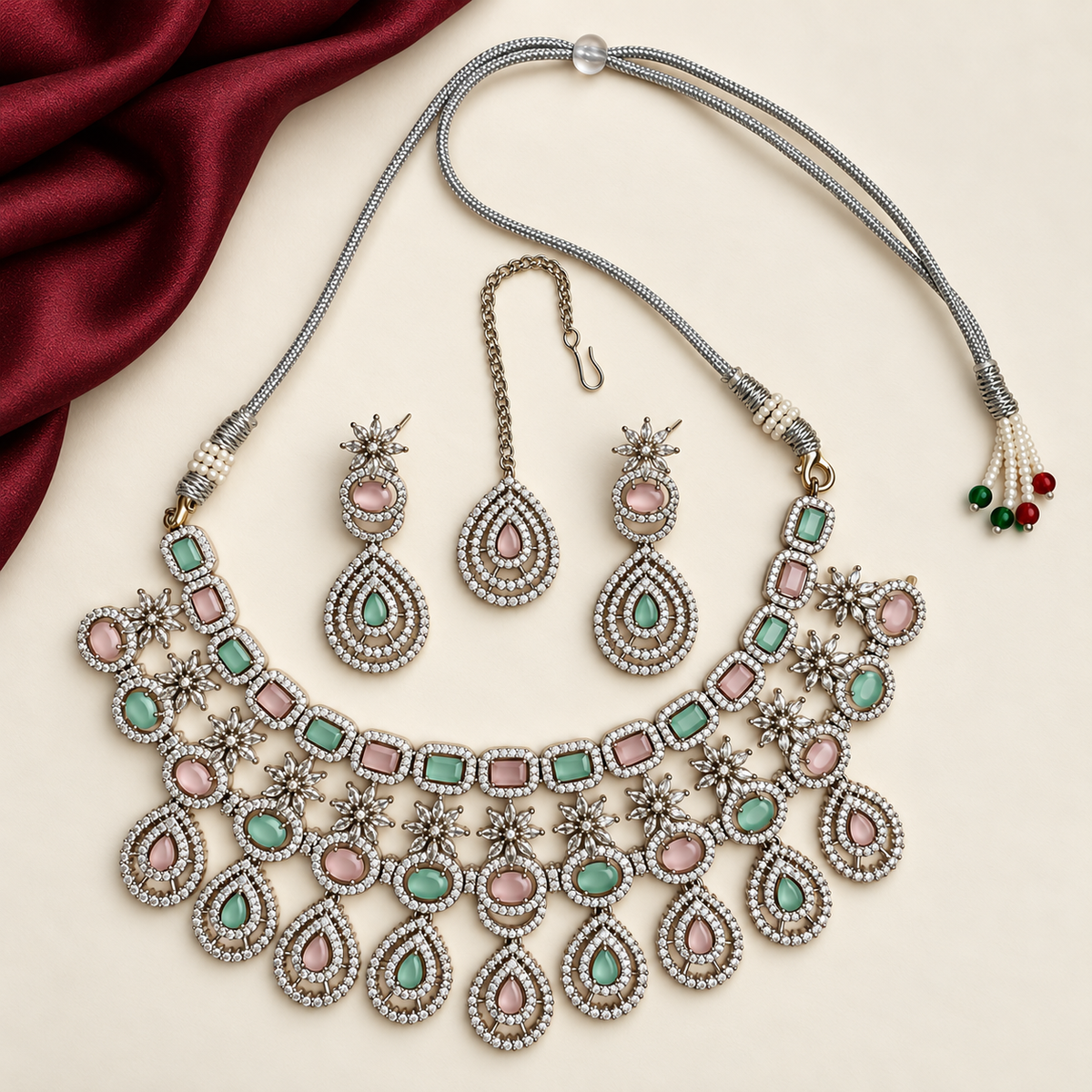 P03 complete necklace, maang tikka and both earrings with a partial burgundy cloth accent